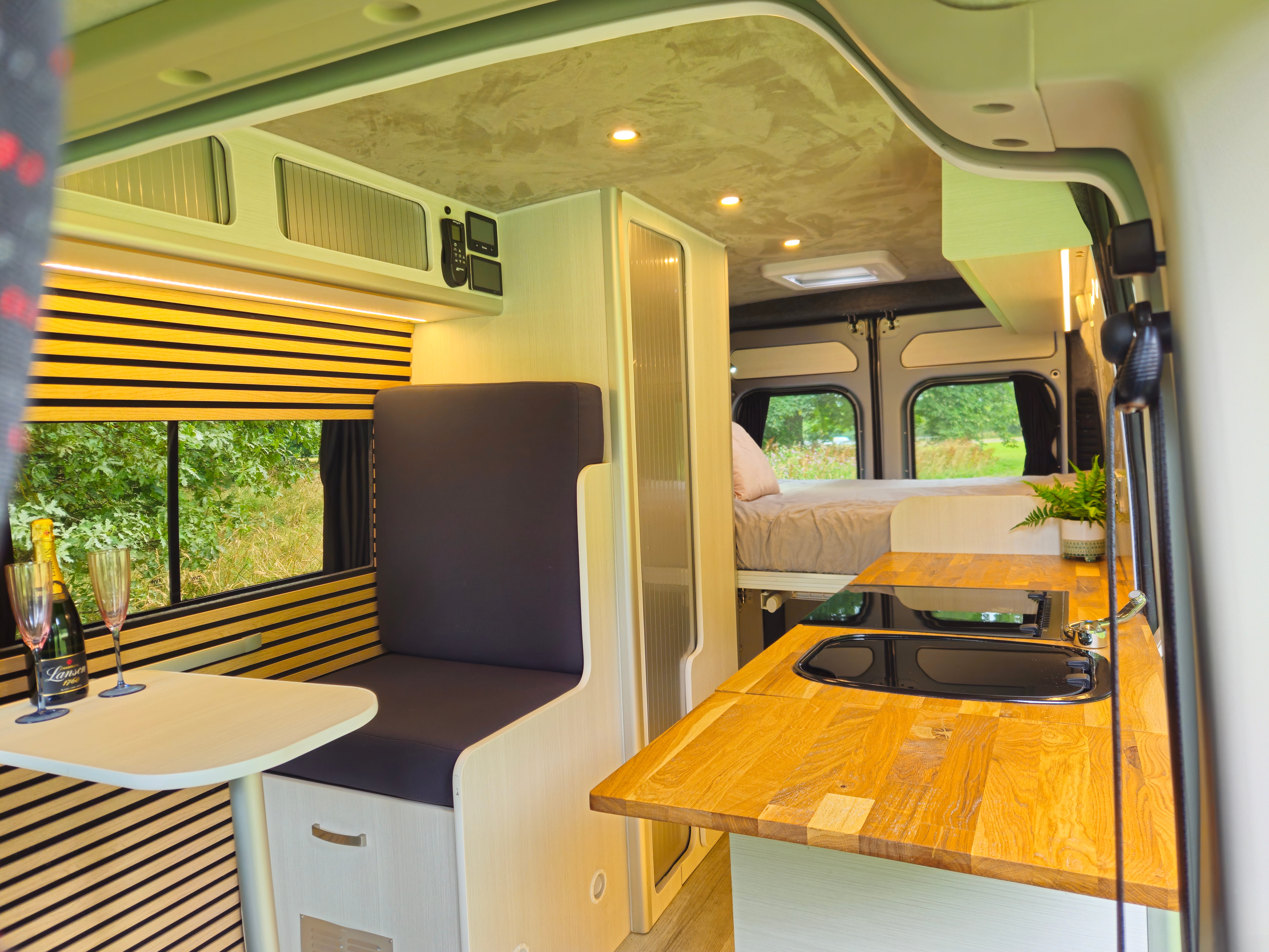 Three-berth layout in a Citroën Relay L3H2 off-grid campervan conversion