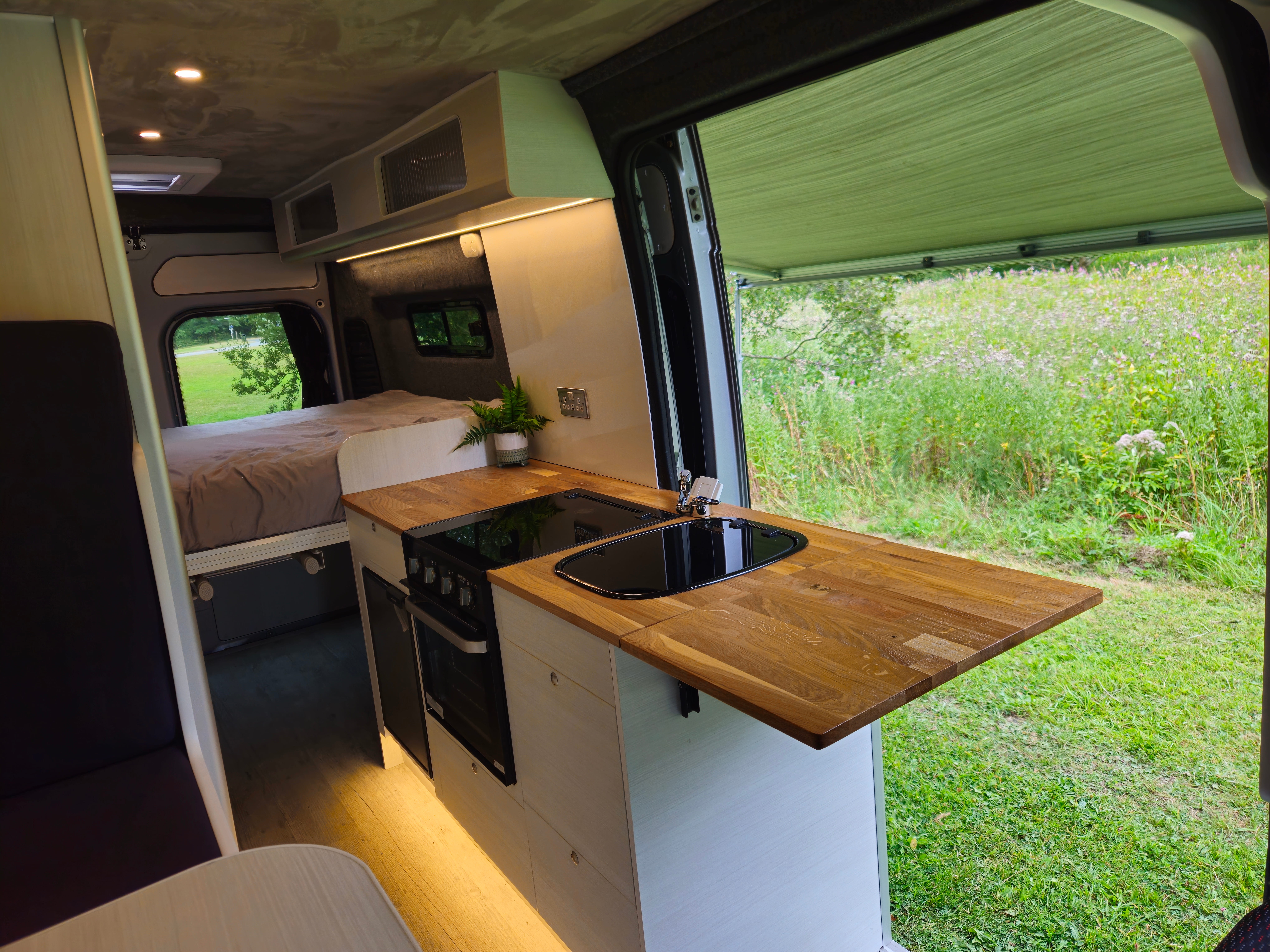 Campervan kitchen with hob, oven and fridge in a Citroën Relay conversion